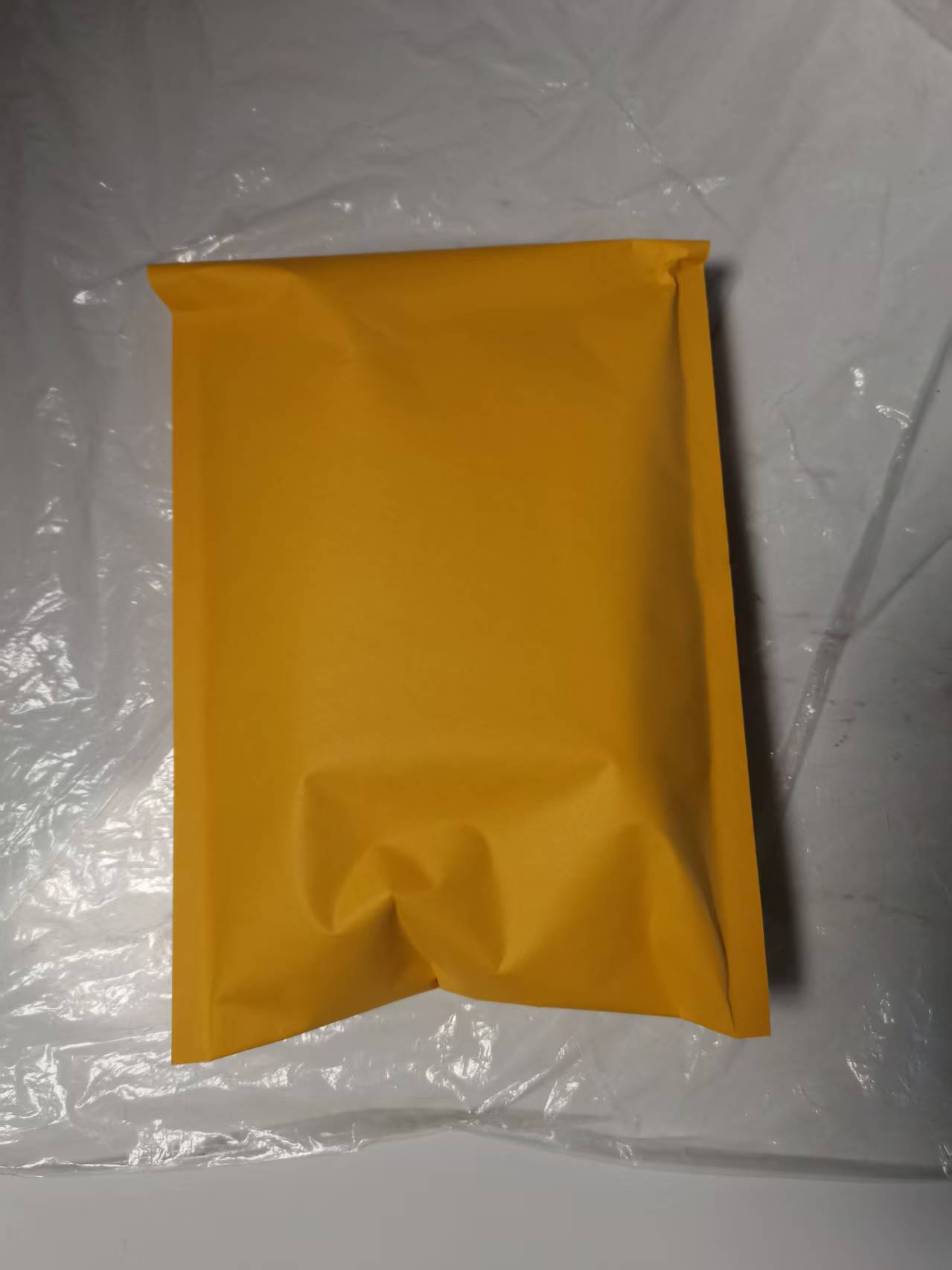Plain yellow mailing pouch used for a single-pair shin guard order