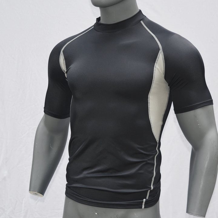 Black short-sleeve rash guard with beige mesh side panels on a mannequin, front view