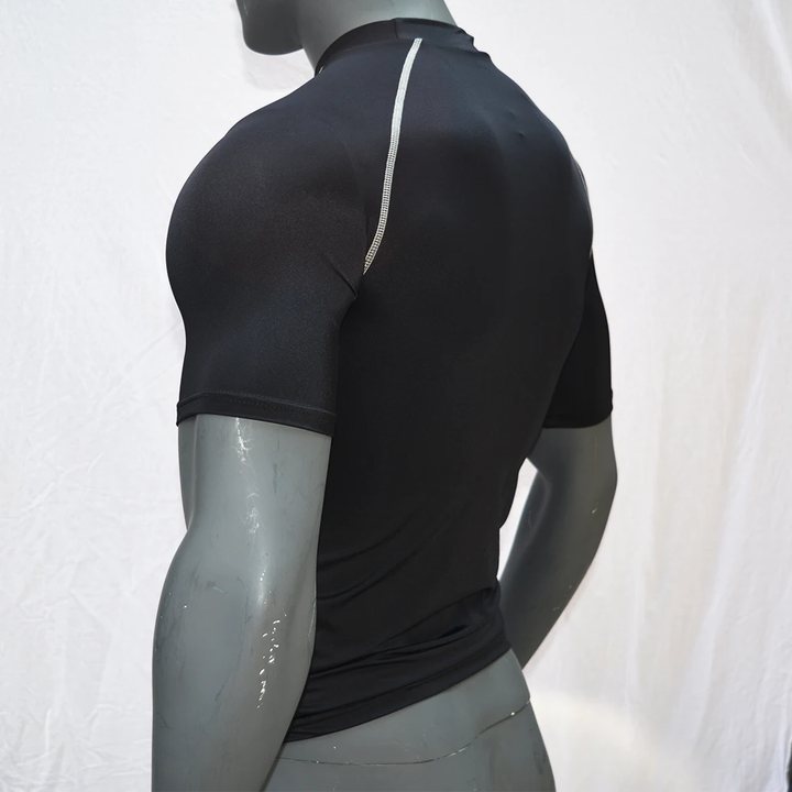 Black short-sleeve rash guard on a mannequin, back view showing the shoulder seam