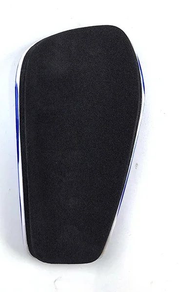 Foam-lined back of a blue full-size shin guard, printed shell edge visible