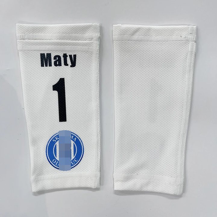 Shin guard sleeve printed 'Maty 1' beside a plain white sleeve