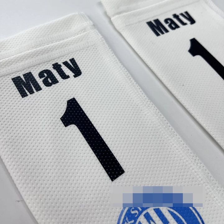 Close-up of white shin guard sleeves printed 'Maty 1'